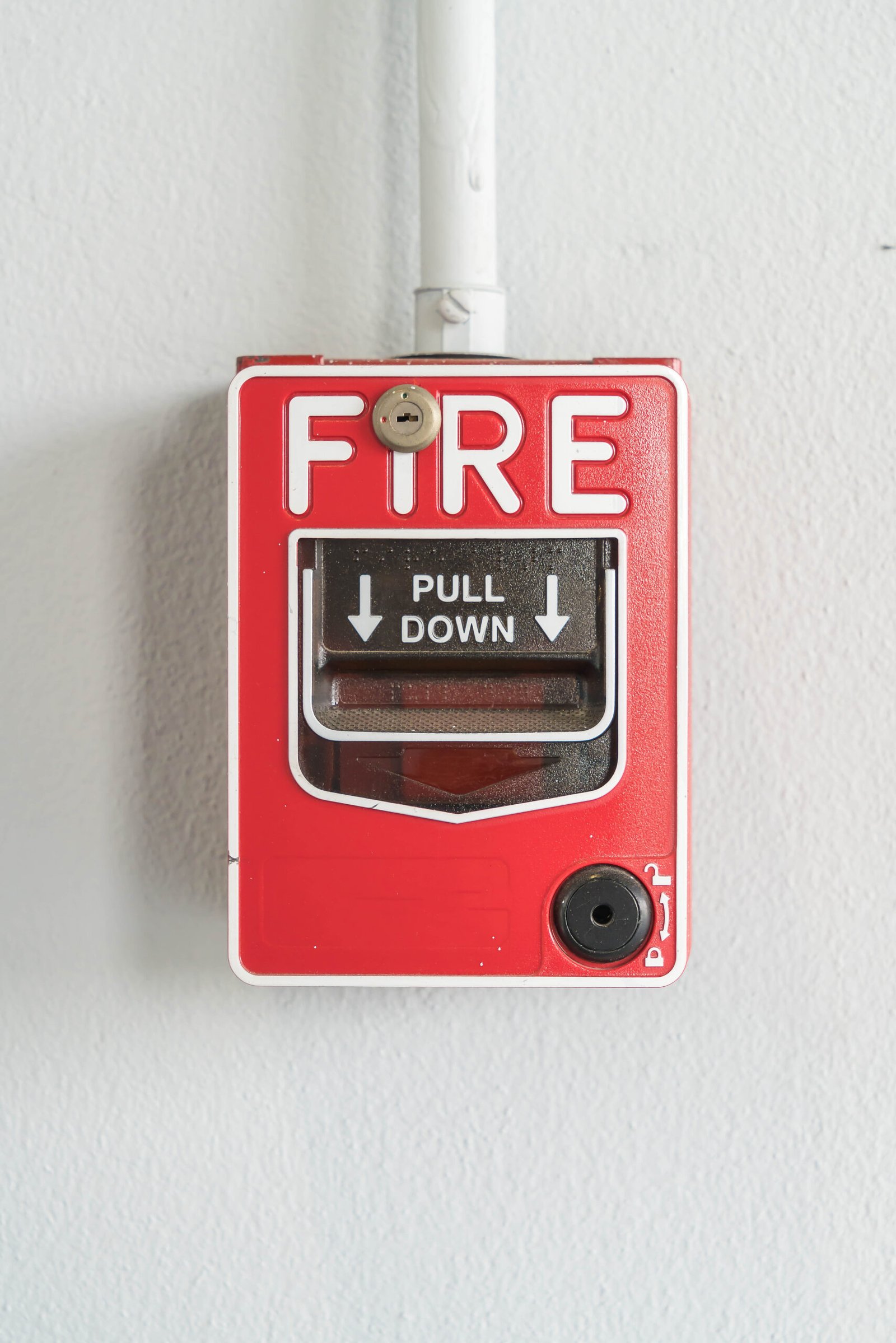 Fire alarm switch on white wall